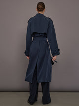 Model is wearing Elva Trench Coat in Navy, full back view with belt and vent detail.