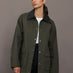 Model is wearing the utility barn jacket in dark olive, front view.