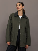 Model is wearing the utility barn jacket in dark olive, front view.