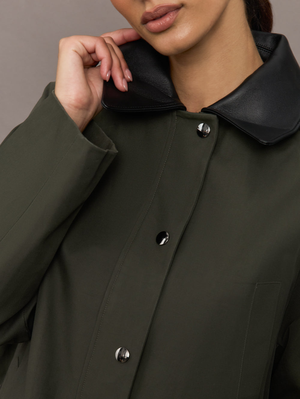 Close up of the utility barn jacket in dark olive, contrast collar detail.