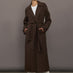 Model is wearing the belted maxi coat in brown, front view.