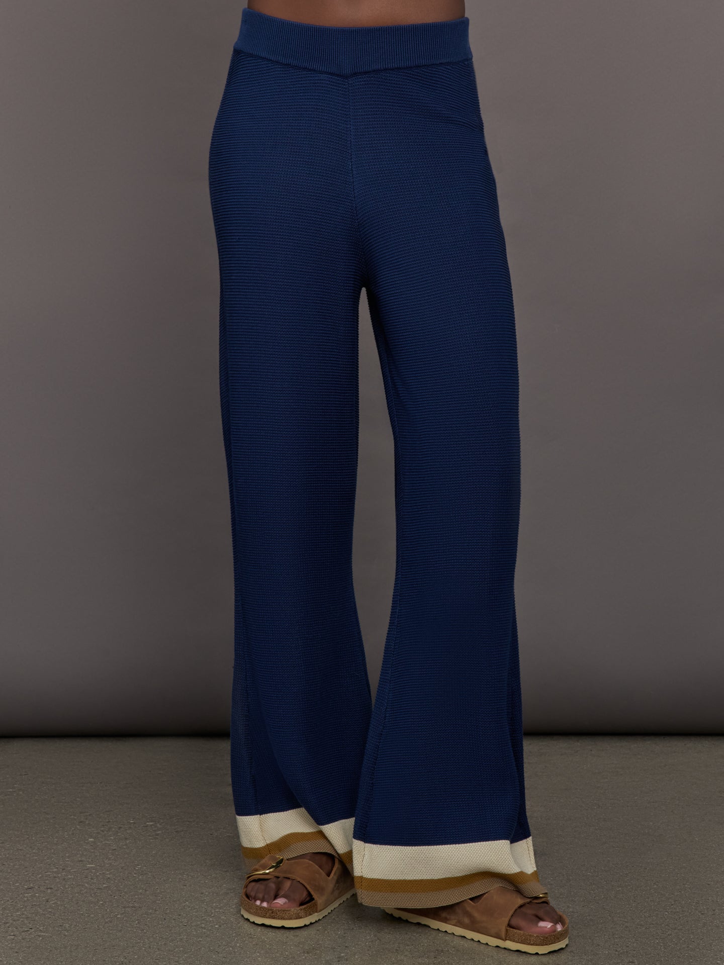 Model is wearing the Florida Knit Pants in Atlantic Stripe, front view with flared leg.