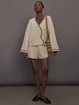 Model is wearing the Yumi Short in Fawn with matching top, full body front view.