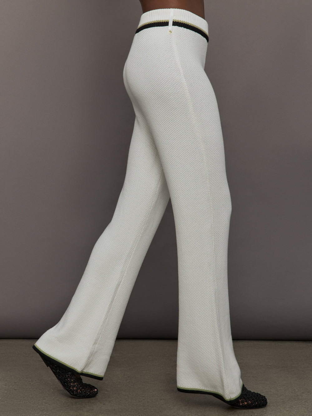 Model is wearing the Soraya Knit Full-Length Pant Sea Salt, side walking view.