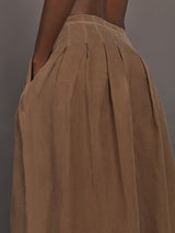 Close up of the Coconut cupro pleated wide leg pant, waistband and pleat detail.