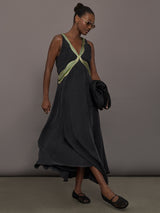 Model is wearing the Onyx embroidered cupro maxi dress walking, full body view.