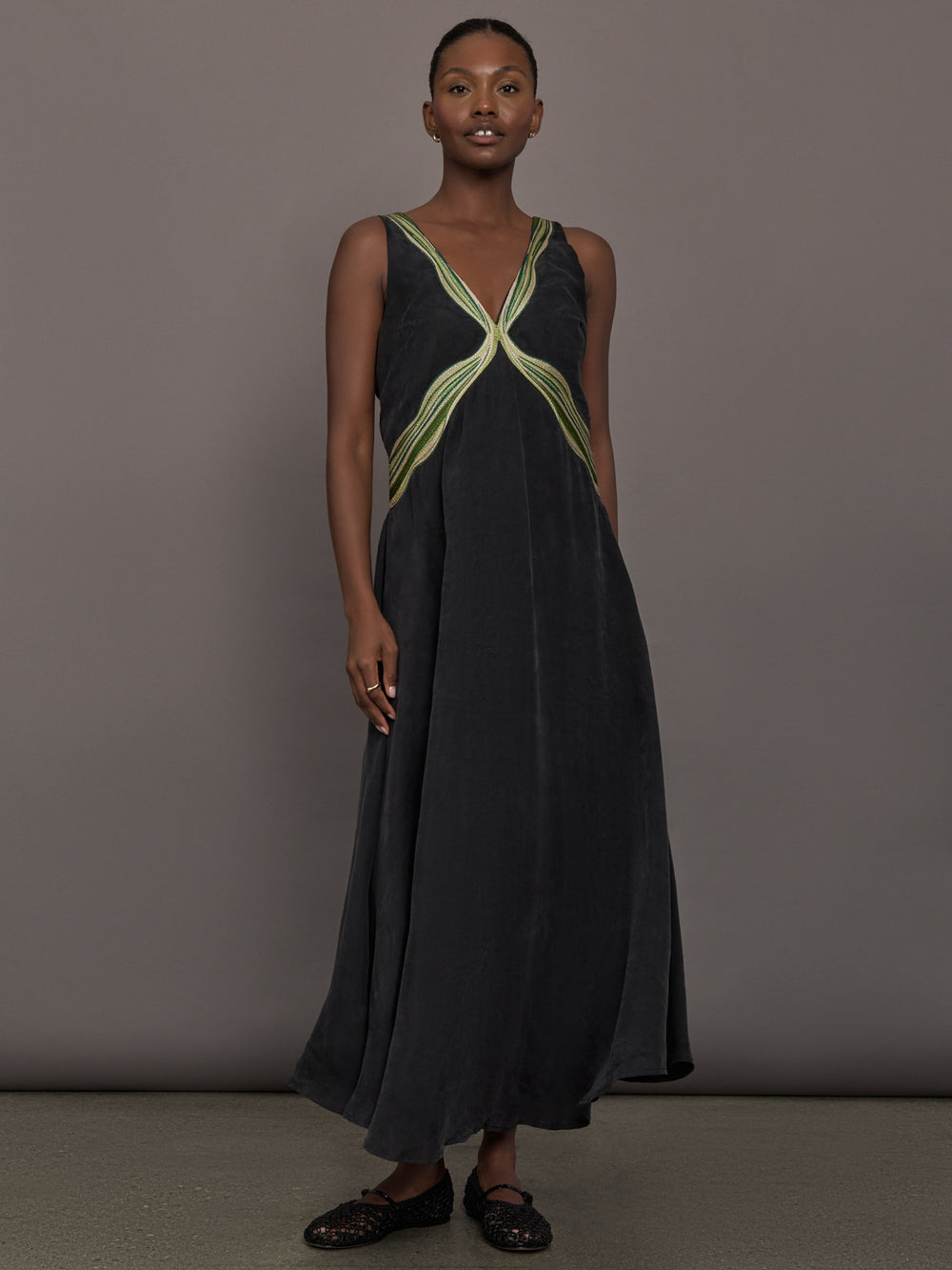 Model is wearing the Onyx embroidered cupro maxi dress, front view.