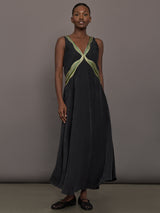 Model is wearing the Onyx embroidered cupro maxi dress, front view.