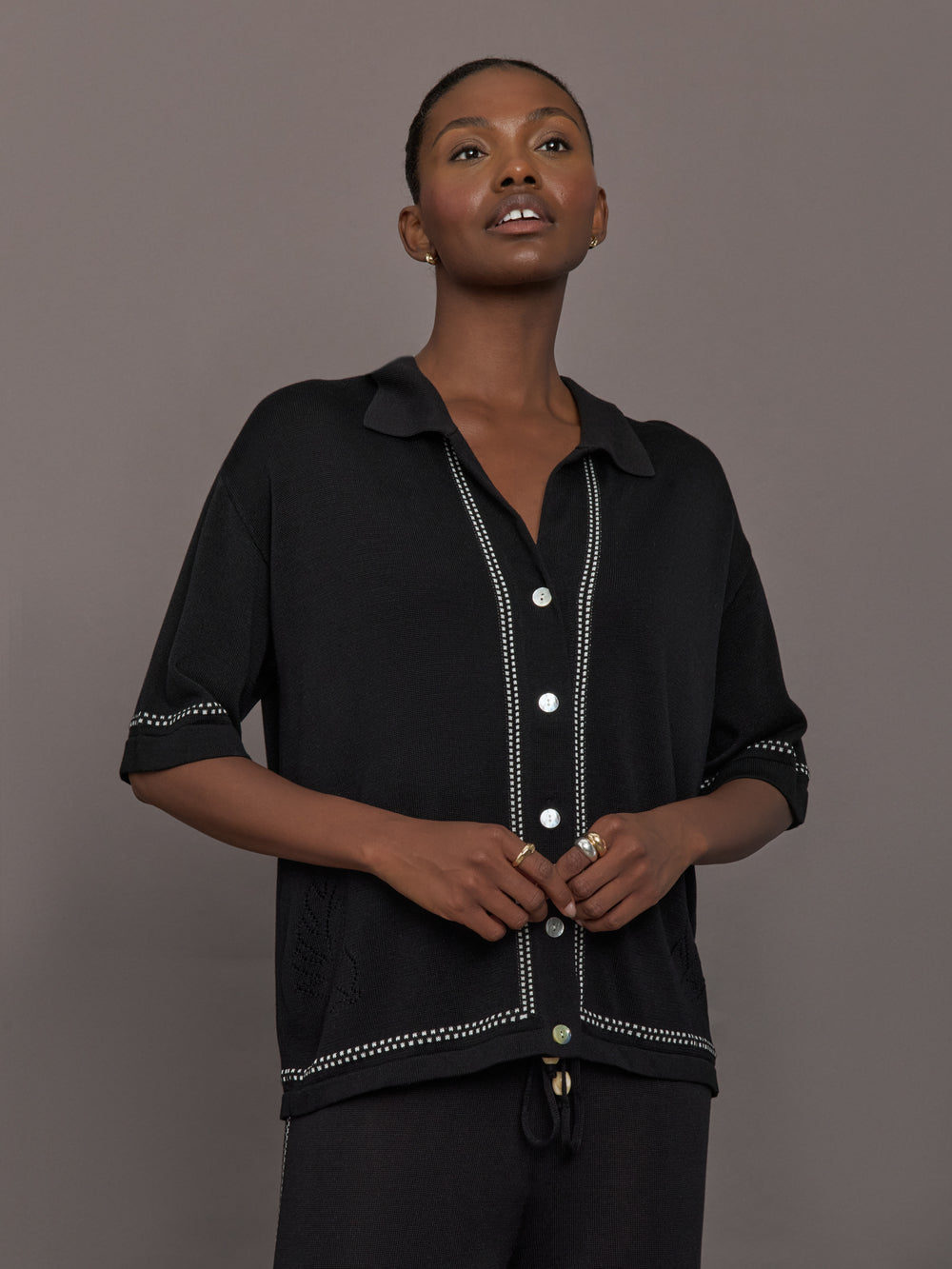 Model is wearing the Coco Knit Shirt Ink, front view showing collar and button detail.