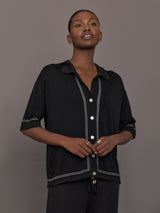 Model is wearing the Coco Knit Shirt Ink, front view showing collar and button detail.