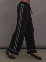 Model is wearing the Lawrence Knit Pant Ink, side walking view.