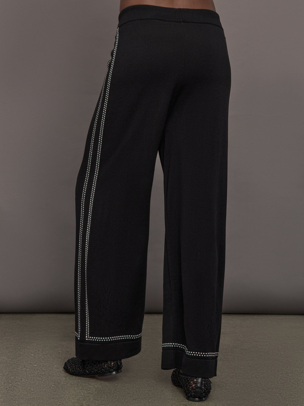 Model is wearing the Lawrence Knit Pant Ink, back view.