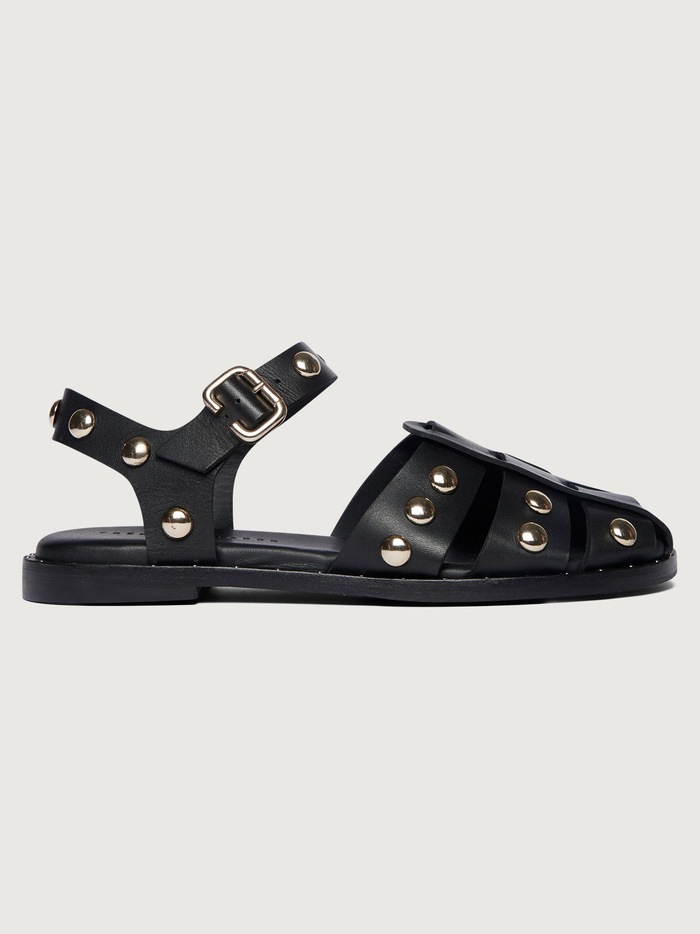 Black leather slingback sandal with round gold studs. 