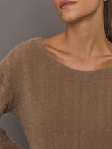 Close-up of taupe plush long-sleeve top with soft textured fabric and wide neckline, close-up front view.