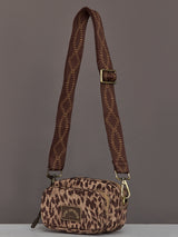 Crossbody bag with an animal print design, structured shape, adjustable strap, and zippered closure.