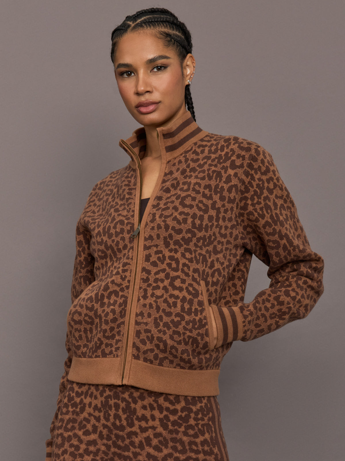 Model is wearing Malawi Knit Zip Front Jacket in Leopard, front view.