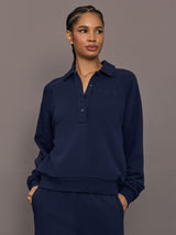 Model is wearing Collared Elle Polo in navy, front view with button placket.