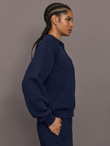 Model is wearing Collared Elle Polo in navy, side view showing relaxed fit.