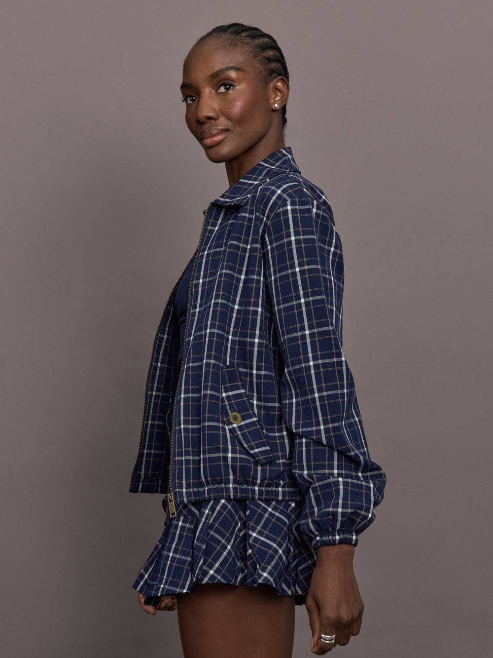 Model is wearing Check Jacquard Zip-Front Bomber Jacket in Navy, side view.
