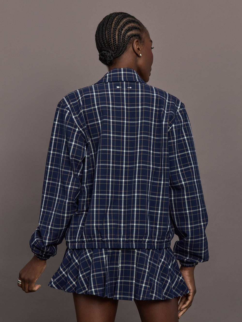 Model is wearing Check Jacquard Zip-Front Bomber Jacket in Navy, back view.