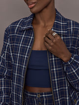 Model is wearing Check Jacquard Zip-Front Bomber Jacket in Navy, zipper close-up.