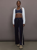 Model is wearing Spellbound Racerback Sports Bra in Polka Dot, full body view.