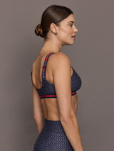 Model wears the Cavallo Scoop Neck Nina Bra in Abstract with a scoop neckline and an artistic print with a supportive, form-fitting design