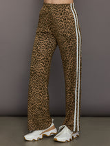 Model wears relaxed-fit pants with animal print, two white stripes down the side and an elastic waistband.