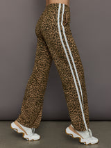 Model wears relaxed-fit pants with animal print, two white stripes down the side and an elastic waistband.
