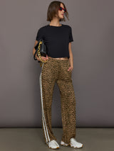 Model wears relaxed-fit pants with animal print, two white stripes down the side and an elastic waistband.