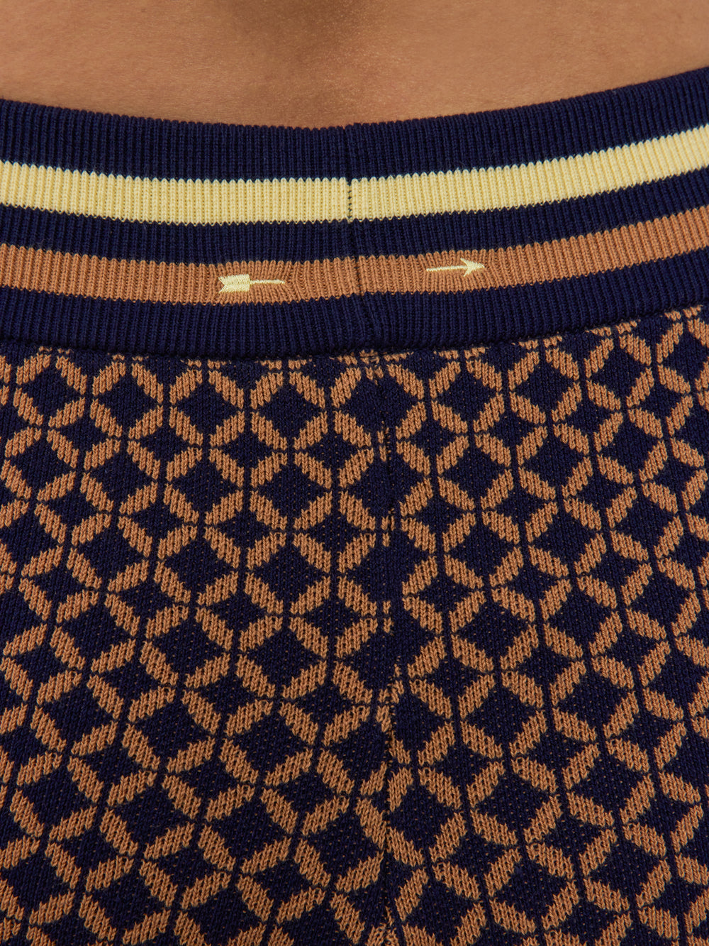 Model wearing patterned shorts with a mid-rise waist.