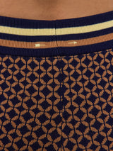 Model wearing patterned shorts with a mid-rise waist.