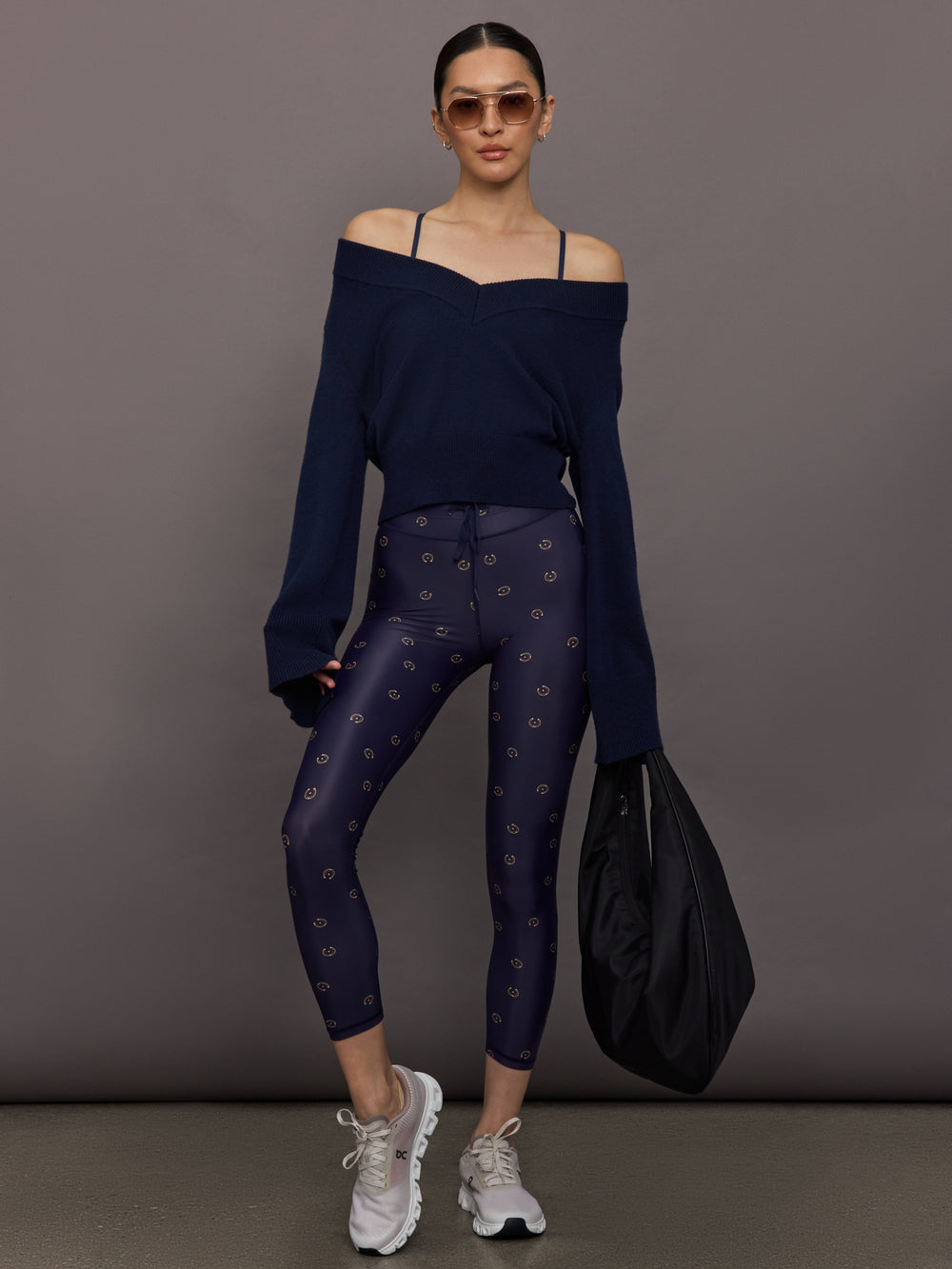 Model wearing a navy blue sports bra with a subtle pattern.