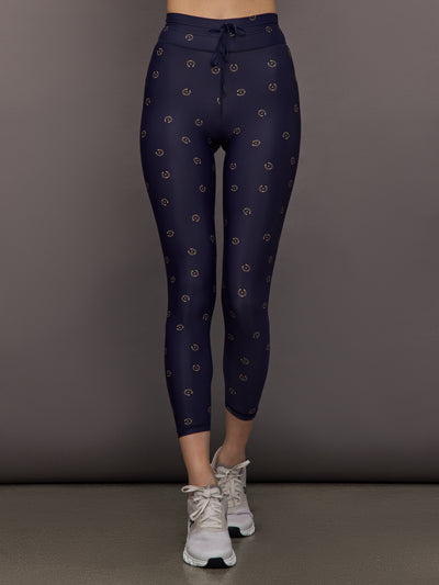 Model wears navy leggings with a subtle horseshoe pattern.