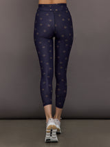 Model wears navy leggings with a subtle horseshoe pattern.