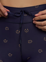 Model wears navy leggings with a subtle horseshoe pattern.