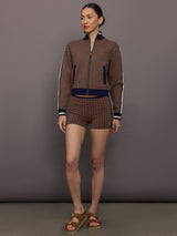 Model wearing patterned shorts with a mid-rise waist.