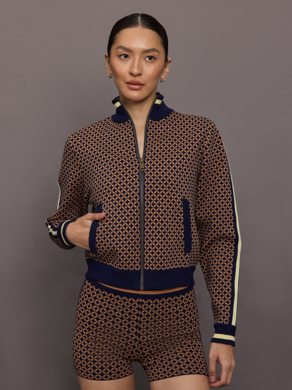 Model wearing a geometric patterned track jacket.