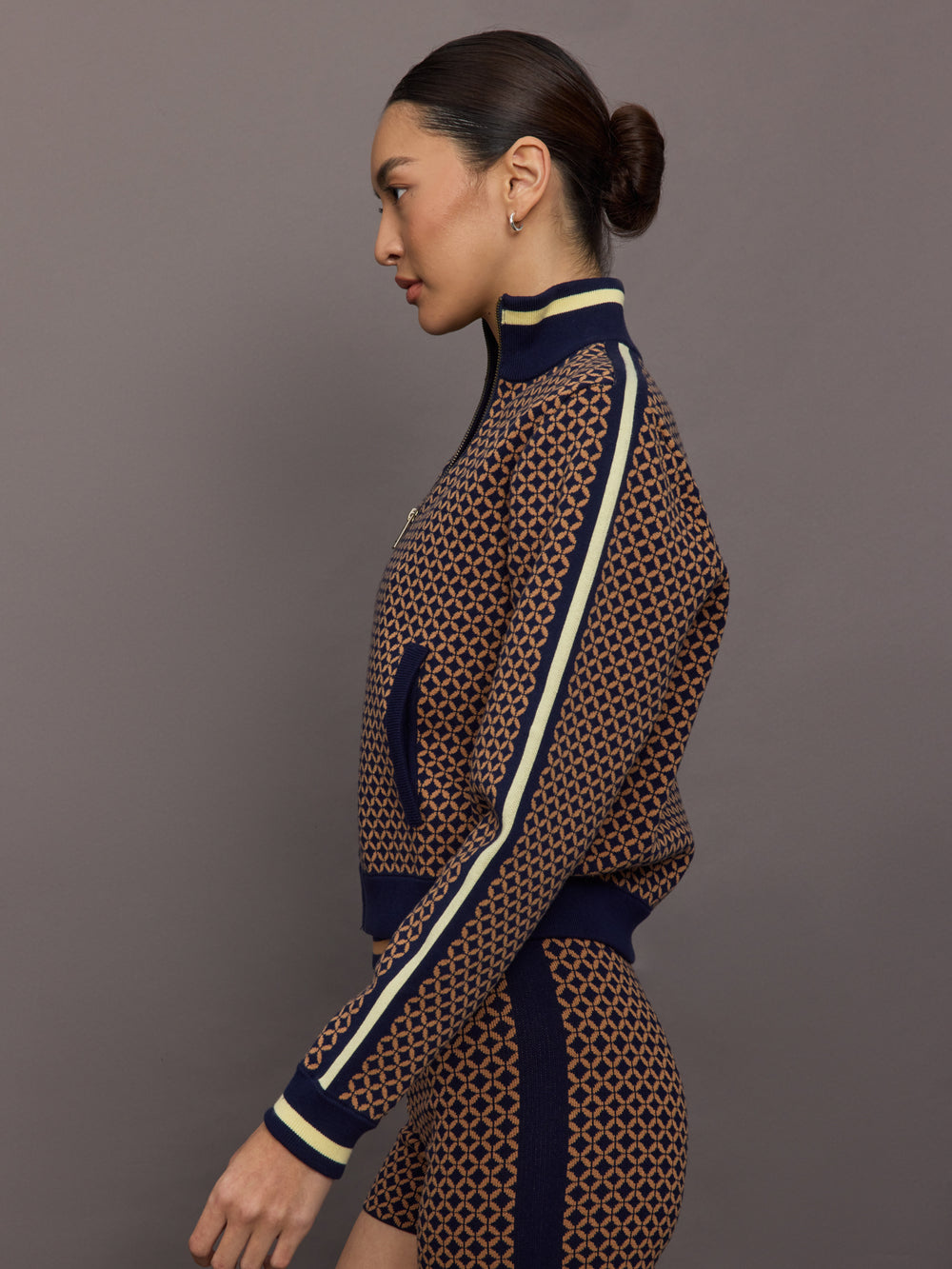 Model wearing a geometric patterned track jacket.