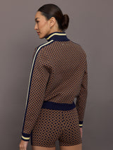 Model wearing a geometric patterned track jacket.