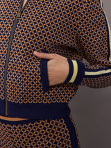 Model wearing a geometric patterned track jacket.