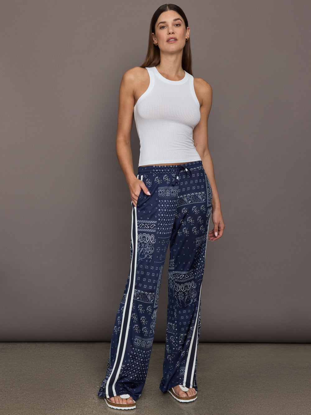 Model wears the Vaquero Roma Pant in Paisley with a relaxed, loose-fitting silhouette and an intricate paisley print.