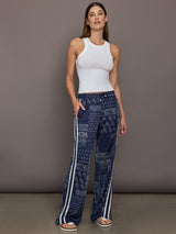 Model wears the Vaquero Roma Pant in Paisley with a relaxed, loose-fitting silhouette and an intricate paisley print.