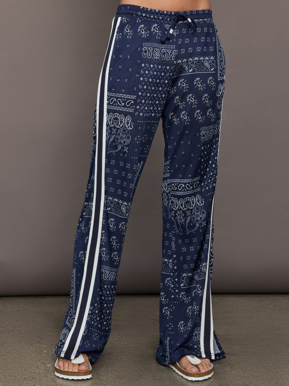 Model wears the Vaquero Roma Pant in Paisley with a relaxed, loose-fitting silhouette and an intricate paisley print.
