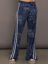 Model wears the Vaquero Roma Pant in Paisley with a relaxed, loose-fitting silhouette and an intricate paisley print.