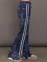 Model wears the Vaquero Roma Pant in Paisley with a relaxed, loose-fitting silhouette and an intricate paisley print.