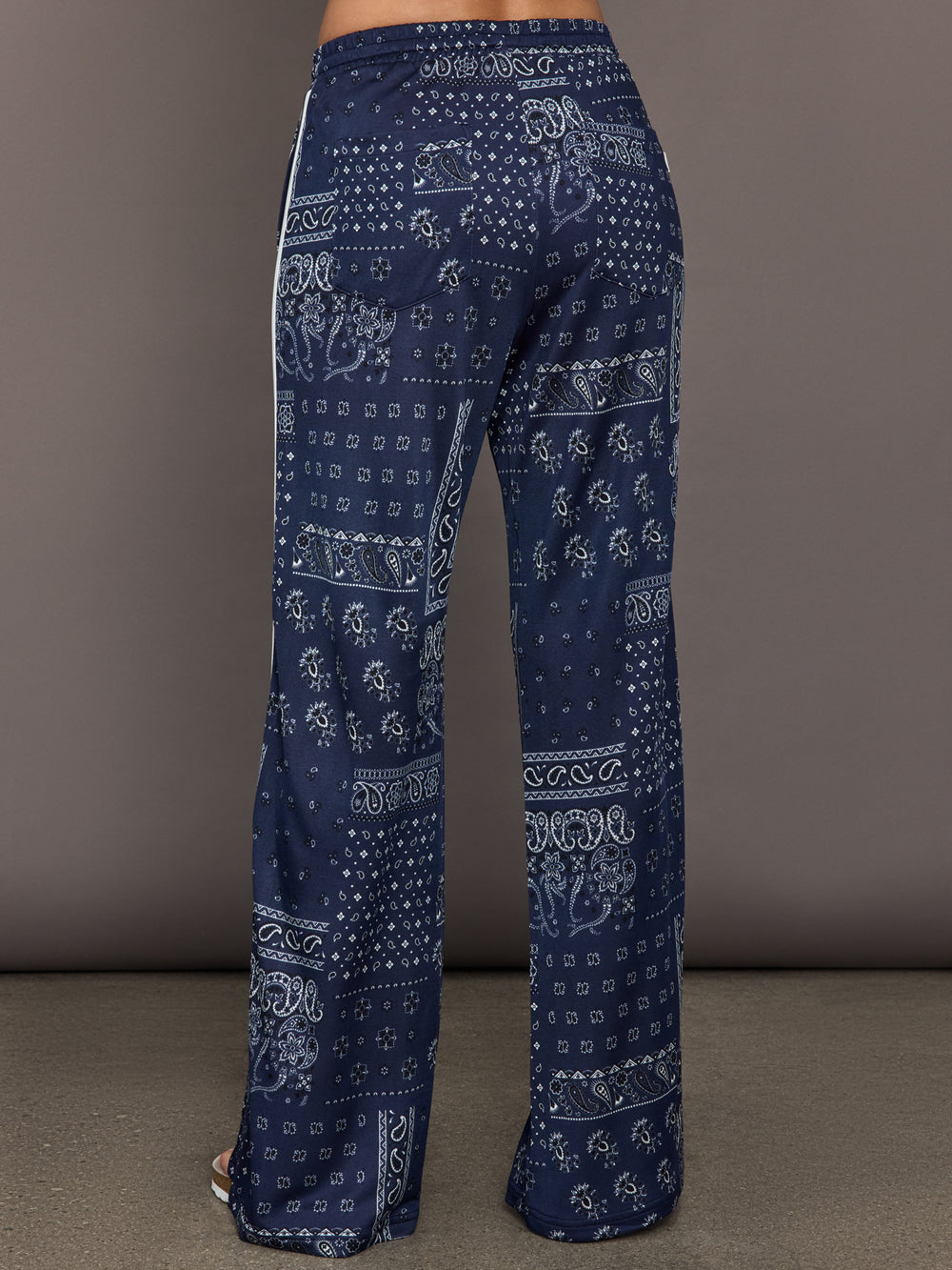 Model wears the Vaquero Roma Pant in Paisley with a relaxed, loose-fitting silhouette and an intricate paisley print.
