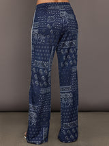 Model wears the Vaquero Roma Pant in Paisley with a relaxed, loose-fitting silhouette and an intricate paisley print.