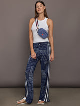 Model wears the Vaquero Roma Pant in Paisley with a relaxed, loose-fitting silhouette and an intricate paisley print.