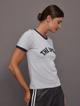 Woman wearing a gray t-shirt with 'THE UPSIDE' text on a plain background